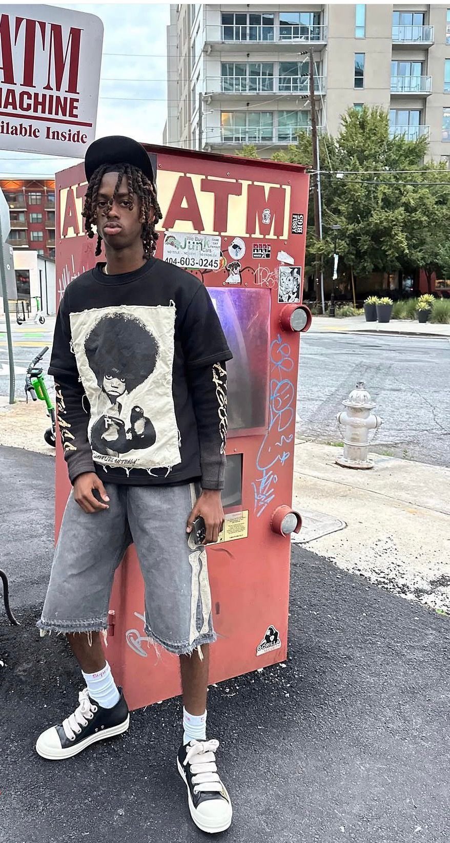Street style portrait beside a vintage ATM machine