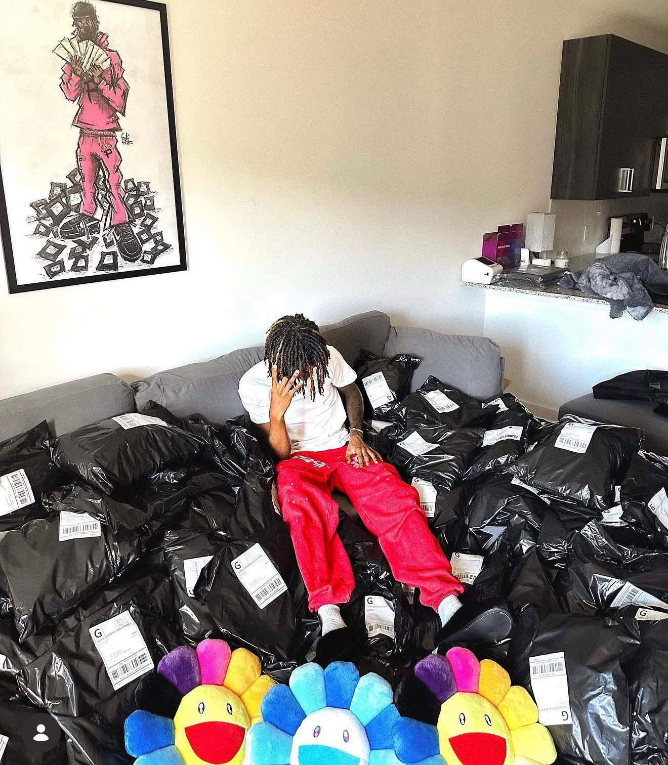 At home surrounded by designer shipments and custom artwork