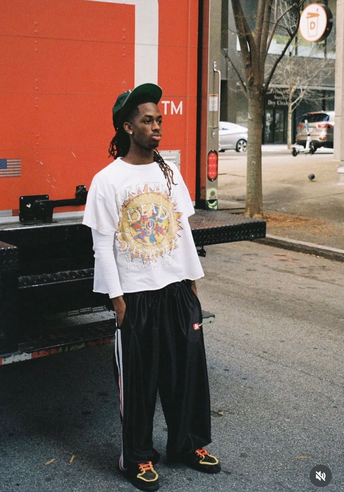 Grateful Dead tee and track pants by an orange truck